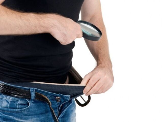 A man looks at his pants and wants to enlarge his penis
